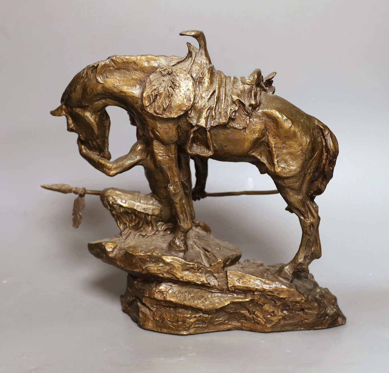 A bronze figure group of a Native American kneeling next to his horse - 'Protector of the Plains' by Buck McCain, 30cm